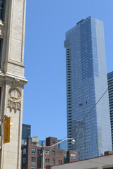 Obraz premium detail of historic book factory, known as Wesley Building (1913), contrast with mixed-use condo and office tower Thomson Reuters building, Toronto