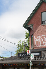 Obraz premium historic house and sign of Dolce Gelato, an ice cream shop, located at 234 Augusta Av, Kensington Market, Toronto