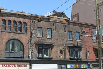 Obraz premium historic commercial block buildings including sign of Balfour Books, located at 468 College St, Toronto