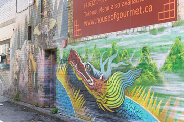 Obraz premium dynamic, colorful dragon mural and sign of House Of Gourmet (located at 484 Dundas St W, Toronto)