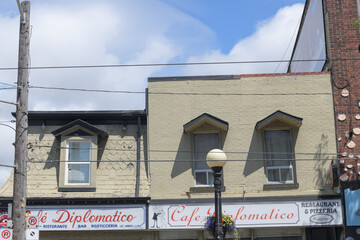 Obraz premium exterior building facade and sign of Cafe Diplomatico Restaurant & Pizzeria located at 594 College St, Little Italy, Toronto