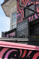 Obraz premium exterior building and sign of DayTrip - Magic Mushroom Dispensary a herbal medicine store located at 69 Oxford St, Kensington Market, Toronto