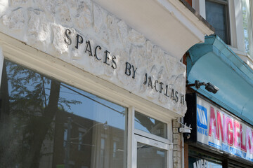 Obraz premium exterior building facade and sign of Spaces by Jacflash, an interior designer, located at 1088 College St, Toronto