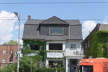 Obraz premium exterior building facade and sign of O'Reight Law located at 598 St Clair Av W, Toronto