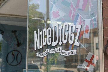 Obraz premium vinyl window sign at Nice Diggz Midtown, a dog day care center, located here at 571 St Clair Av W, Toronto