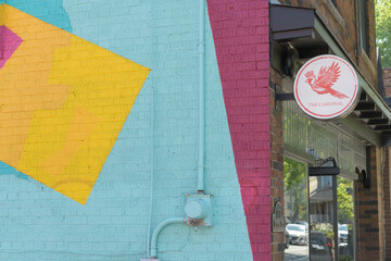 Obraz premium round wall-mounted projecting sign and exterior wall mural outside The Cardinal Gallery at 1231 Davenport Rd (painted by Arlin Graff), Toronto