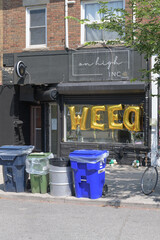 Obraz premium recycling bins on sidewalk outside On High Inc, a cannabis store, located at 806A St Clair Av W, Toronto