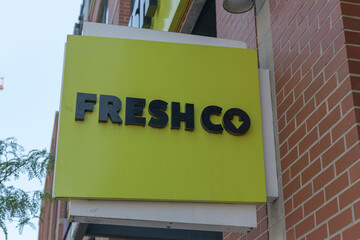 Obraz premium wall-mounted projecting sign of FreshCo, a supermarket chain, located here at 410 Bathurst St & Nassau St, Toronto