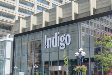 Obraz premium exterior building facade and sign of Indigo, a book store chain, located here at 55 Bloor St W inside Manulife Centre (Bay St side), Toronto