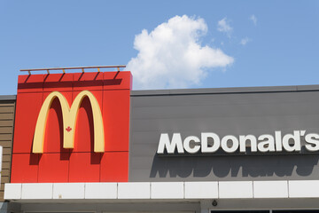 Fototapeta premium exterior building facade and sign of McDonald's Canada fast food restaurant located at 710 St Clair Av W, Toronto
