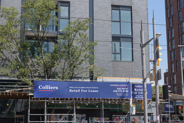 Obraz premium Colliers Retail for Lease sign on the exterior of a new build at 908 St Clair Condos, Toronto