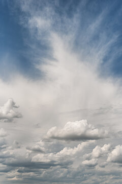 Impressive sky with cirrus and cumulus clouds, vertical frame