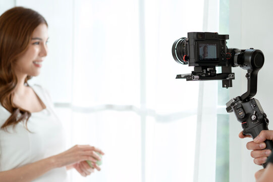 Behind the Scenes of a Video Shoot Featuring a Woman at a Well-Lit Indoor Location