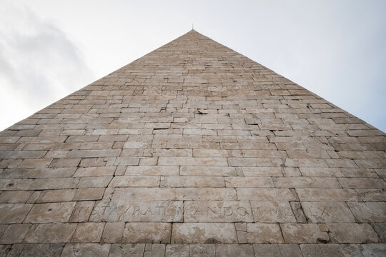 Dramatic symmetrical low angle view looking up the ancient Pyramid of Cestius in Rome, Italy