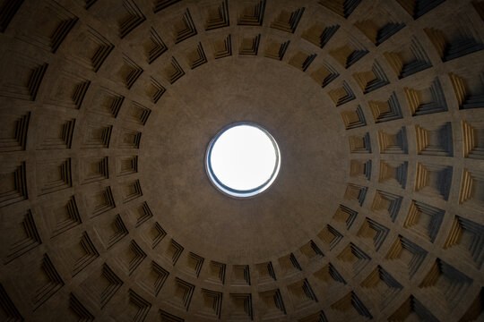 Symmetrical low angle view looking directly up at the oculus and coffered dome of the Pantheon in Rome, Italy