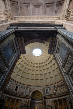 View through the giant ancient bronze doors into the interior and coffered dome of the Pantheon in Rome, Italy