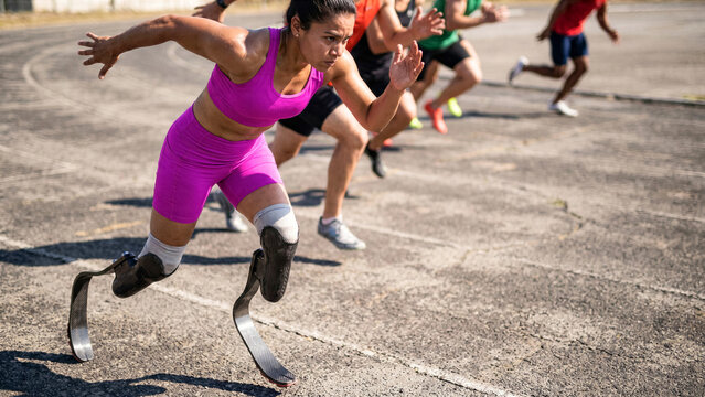 Determined adaptive runner with dual running blades leading sprint race on outdoor track