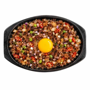 Sizzling sisig with egg yolk served in a cast iron pan, top view, food photography