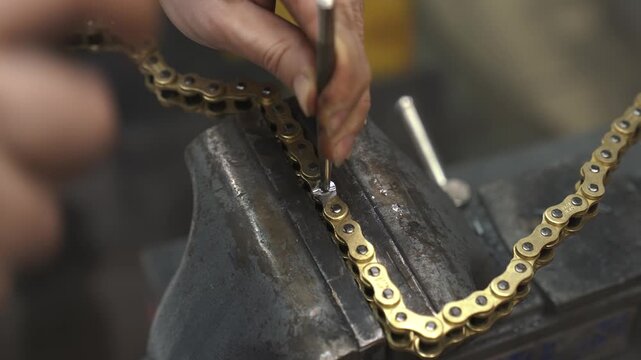 the working engineer separates the links of the chain, removes the extra links by drilling them out, then puts steel teeth on the chain and connects it together
