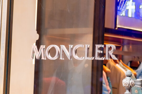 Beautiful Architectural Detail with Moncler Luxury Fashion Brand Sign on Glass Boutique Window. Milan, Italy - June 24, 2026