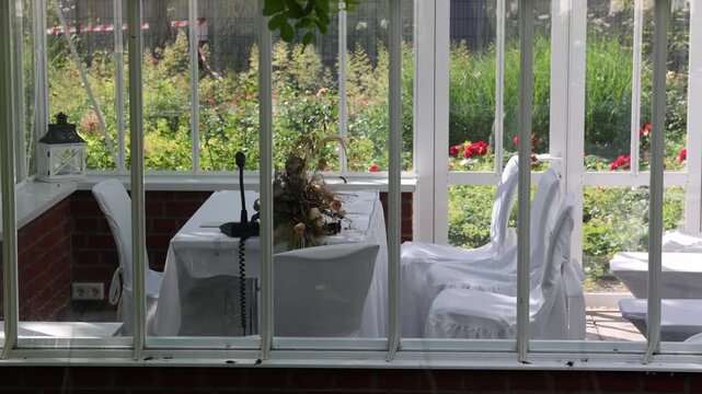Wedding ceremony setup inside a sunny conservatory