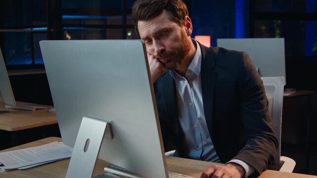 Sleepy bored Caucasian 40s business man working computer yawning at night office overtime late boring middle-aged businessman male entrepreneur yawn work internet desktop suffer burnout lack of energy