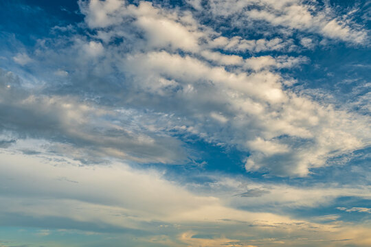 Beautiful vibrant blue sky with fluffy cirrocumulus and altocumulus clouds