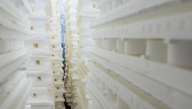 Stacks of white polystyrene insulation sheets forming an abstract industrial background texture