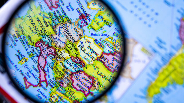 Magnifying glass reveals Germany and Central Europe on detailed world political map.