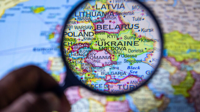 Map of Eastern Europe under magnifying glass. Focus on Ukraine and Belarus