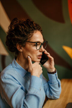 Businesswoman talking on phone discussing important work matters