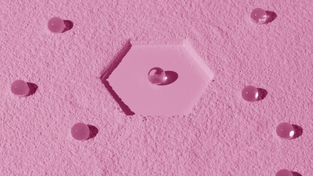 Vertical jib high-angle shot of pale pink fine-textured powder surface with hexagonal imprint and hydrogel spheres chaotically laid over the surface lit by orbiting light casting dynamic shadows