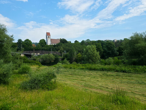 germany, peaceful st blasius church surrounded by green meadows and lush trees beneath brilliant blue summer sky in plochingen landscape
