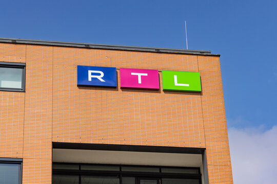 Hilversum, Netherlands - July 13, 2026: The colorful blue, pink, and green rectangular block logo sign for commercial broadcaster RTL on a brick building exterior facade.