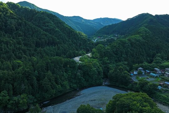 Aerial drone photo of Akigawa Valley surrounded by green mountains, Tokyo, Japan