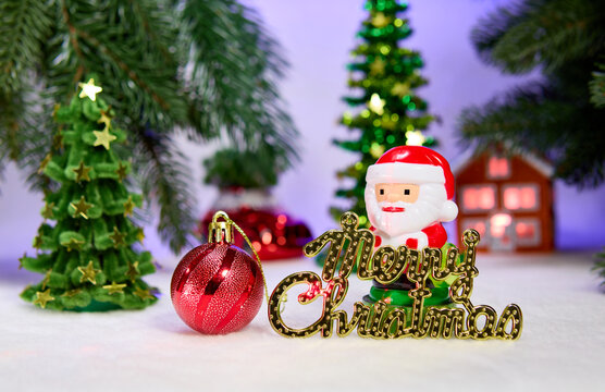Santa Claus with letters and a small ball against the background of Christmas trees with a house and a car