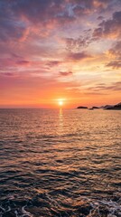 Fototapeta premium Vibrant sunset over the ocean with purple and orange clouds