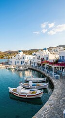 Fototapeta premium Traditional white village and fishing boats in a coastal harbor