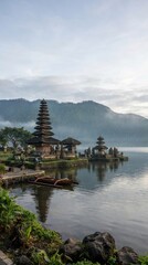 Obraz premium Traditional Hindu water temple with tiered shrines on misty lake at sunrise