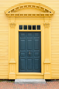 Blue Door on Yellow Building Facade