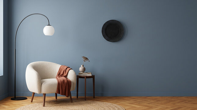 Modern Living Room Ambiance: A minimalist living room features a plush armchair, a sleek arc lamp, and a small side table adorned with decor, all set against a calming blue wall.
