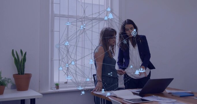 Blazer woman pointing at laptop, holo overlay appearing on screen, peer reaching docs for business