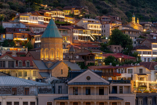 Old tbilisi cityscape at twilight, traditional wooden balconies