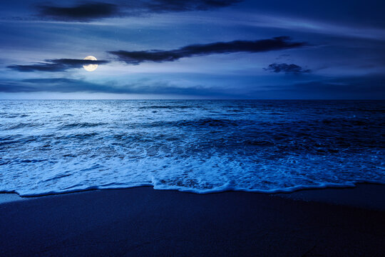 black sea landscape in summer at night. full moon over bulgaria nature landscape with sandy beach. mysterious summer vacation at the sea shore concept. waves and empty beach. remote vacation scene