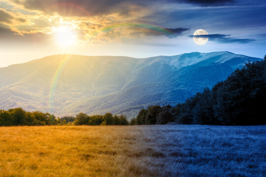 mountain landscape of ukraine. day meet night. sun and moon over alpine grassy meadow and deciduous forest on the hill. equinox nature background for carpathian adventures