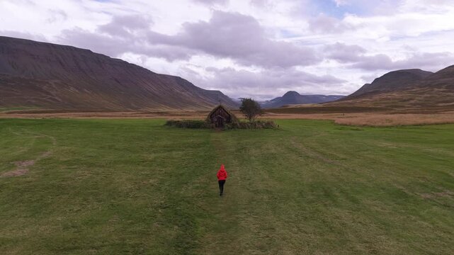 Tourist visiting Grafarkirkja oldest church in West Iceland . Aerial overview