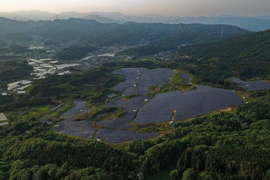 Aerial drone photo of large solar farm in mountainous Takayama Village, Gunma, Japan at sunset