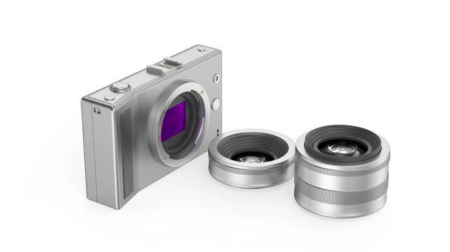 Silver mirrorless digital camera with prime and zoom lenses on white background