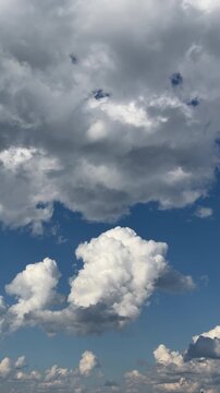 Cumulus cloud vertical time lapse over deep blue summer sky