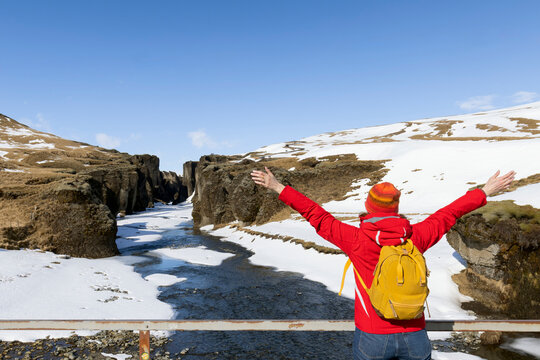 Woman traveller hike Fjadrargljufur in Iceland. Top tourism destination. Fjadrargljufur Canyon is a massive canyon about 100 meters deep and about 2 kilometers long, located in South East of Iceland.